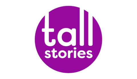 A purple circle with white text reading 'Tall Stories' in the centre.